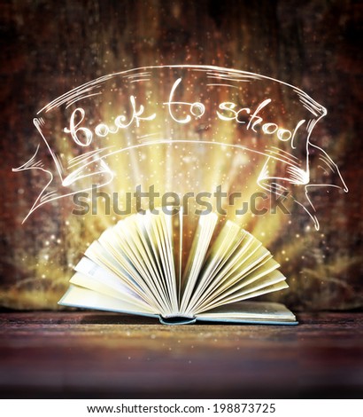 Image of opened magic book with magic lights/ \
