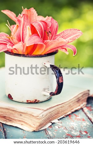 bunch of lily flowers on old vintage book in the garden