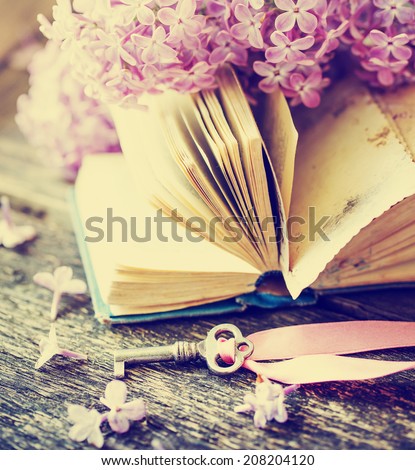 Nostalgic vintage background/ Vintage book,Photos of Memories and key with lilac flower