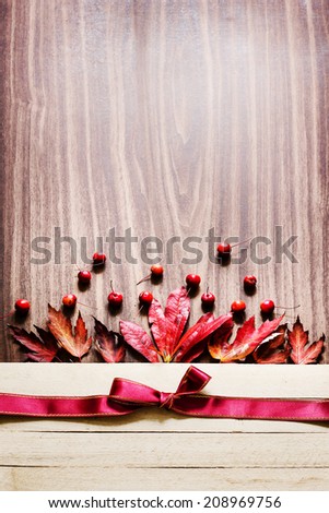 Autumn background/Autumn leaves and berry over wooden background/ Thanksgiving day concept