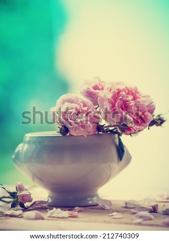 Pink roses in a vase in vintage style/ Valentines day background