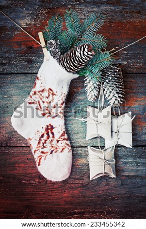 christmas composition with socks, present boxes fir and fir-cone on wooden background/ Christmas card with christmas rustic decorations