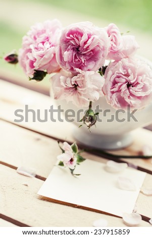 Beautiful roses in a vase in vintage style/ Gentle flower background