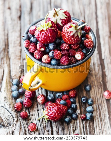 Berries on Wooden Background. Summer or Autumn Organic Berry over Wood. Agriculture, Gardening, Harvest Concept.