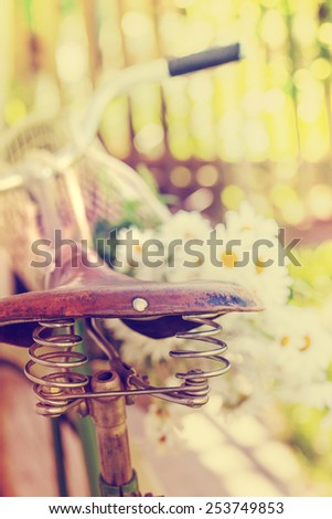 Vintage Bike HandleBar with flowers and Colorful Background Bokeh /summer background with bicycle (toned picture)