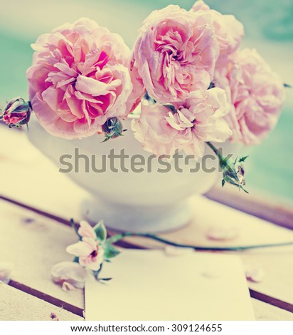 Beautiful roses on desk wooden background/ holidays romantic background