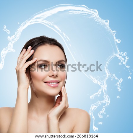 Closeup portrait of beautiful young woman over blue background with water splash. Isolated. Copy space. Square composition.