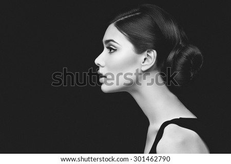 Closeup shot of beautiful young woman profile over black background