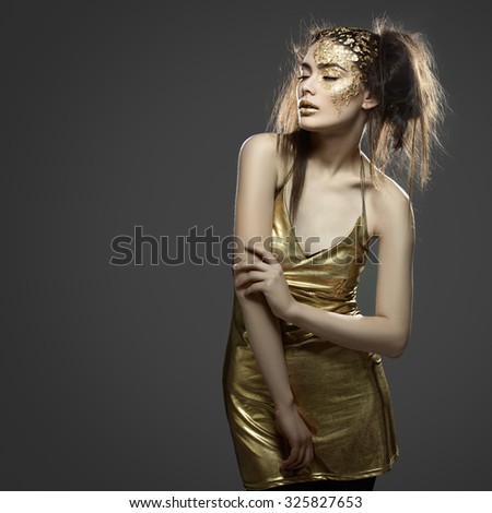 Beautiful young woman in dress with art golden foil makeup on face and lips. Square composition. Copy space. Over grey background.
