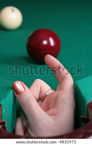 two balls on the billiards table and woman\'s hand