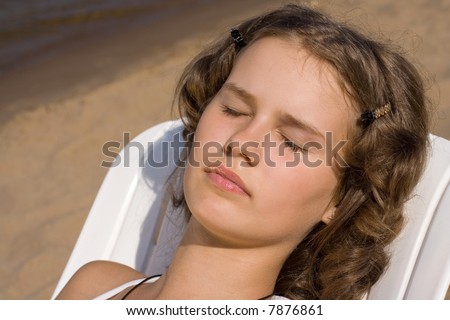 A girl takes sun bath