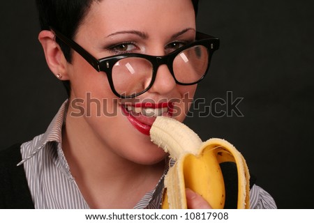 funny woman in glasses with banana over black background