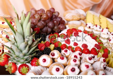 Fancy-cakes with whipped cream decorated with fruit