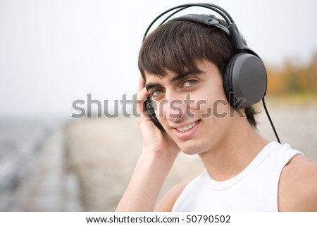 Happy young man listen to music in outdoors