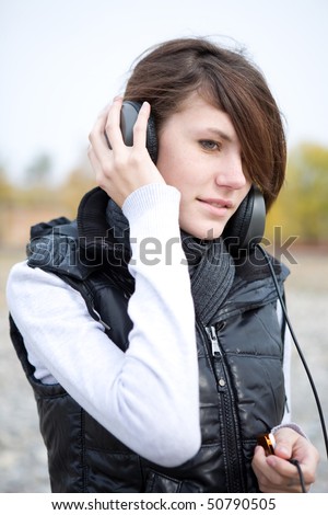 Calm young woman listen to music in outdoors