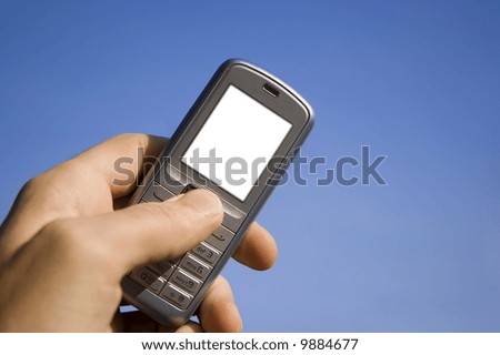 White screen on mobile phone to write it on whatever you want! Mobile in the hand over blue sky