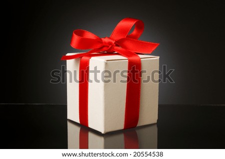 Little white box with red ribbon to celebrate a special Christmas, birthday or any kind of holiday!
