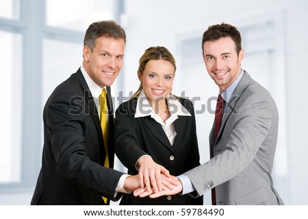 Happy smiling business team holding hands in a heap, good teamwork job