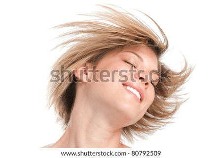 Happy beautiful young girl shaking head with her new straight hairstyle isolated on white background