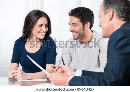 Financial consultant presents bank investments to a young couple