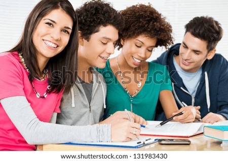 Happy Group Of Young Students Studying Together In LibraryÃ?Â?Ã?Â 