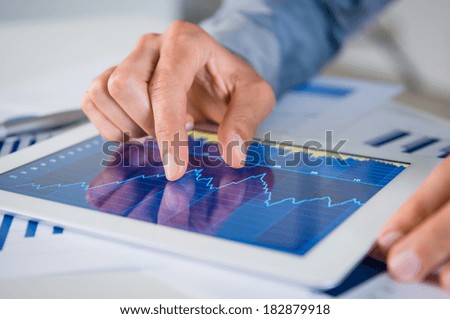 Close Up Of Businessman\'s Hand Analyzing Graph On Digital Tablet