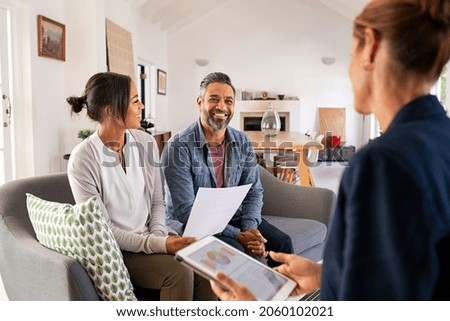 Happy mature couple discussing investments with financial broker during meeting at home. Middle eastern man and woman discussing about financial planning with consultant at home. Financial consultant 