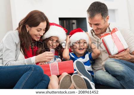 Happy Family Holding Christmas Gift