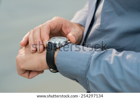 Closeup Of Businessman Hands Checking Time