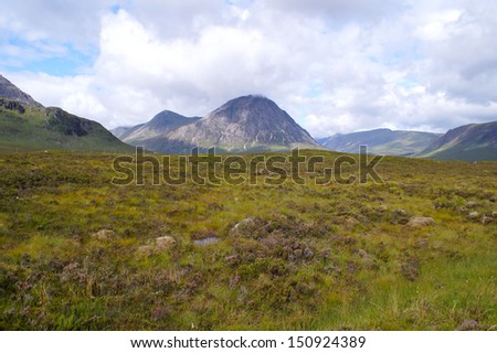 Grass and view to the peak of Buachaille Etive Mor which is one of the best known of all the Munro peaks in Scotland and on The West Highland Way