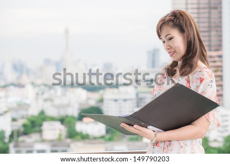 Cute asian businesswoman portrait in office with her file