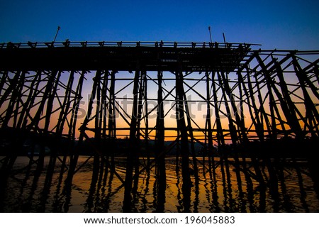 The silhouette of old wooden bridge Bridge collapse Bridge across the river and Wood bridge (Mon bridge )at sangklaburi, kanchanaburi