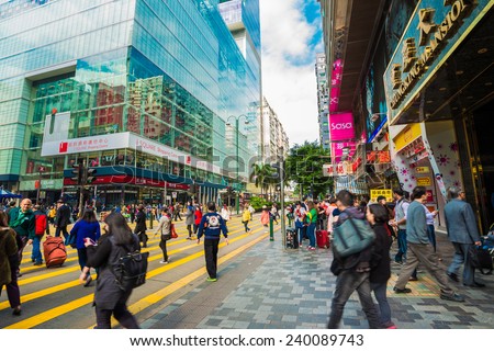 HONG KONG, CHINA - Dec 8: Crowded street view on December 8, 2014 in Hong Kong, China. With 7M population and land mass of 1104 sq km, it is one of the most dense areas in the world.