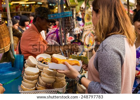 BANGKOK - JAN 25: Coconut vendor in a weekend bazaar on January 25, 2015 in Chatuchak Market, Chatuchak Market is the world largest weekend market covering 27acre with 15,000 booths