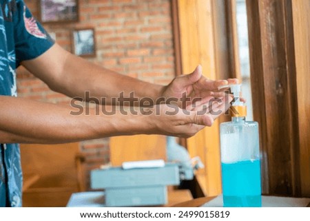 Similar – Image, Stock Photo doctor man using alcohol disinfectant gel. using protective mask and gloves during corona virus covid 2019 pandemic. Health care and medical concept