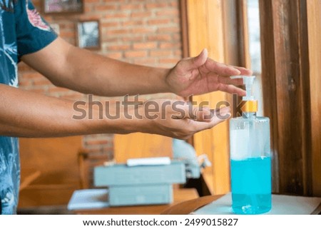 Similar – Image, Stock Photo doctor man using alcohol disinfectant gel. using protective mask and gloves during corona virus covid 2019 pandemic. Health care and medical concept