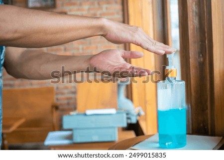 Similar – Image, Stock Photo doctor man using alcohol disinfectant gel. using protective mask and gloves during corona virus covid 2019 pandemic. Health care and medical concept