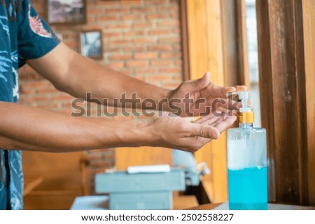 Similar – Image, Stock Photo doctor man using alcohol disinfectant gel. using protective mask and gloves during corona virus covid 2019 pandemic. Health care and medical concept