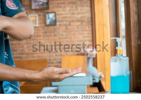 Similar – Image, Stock Photo doctor man using alcohol disinfectant gel. using protective mask and gloves during corona virus covid 2019 pandemic. Health care and medical concept