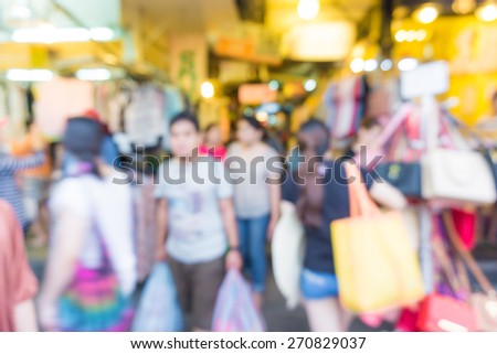 Blur of tourists are walking and shopping in Chatuchak market, largest weekend market in Thailand.