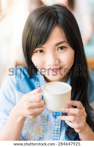 Happy asian young woman sitting in vintage cafe with cup of coffee, Vintage woman coffee