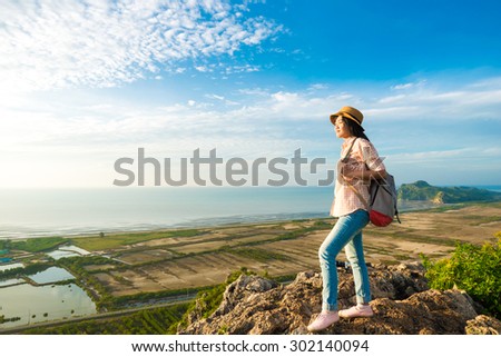 Hiking woman walk on the mountain hill. cheering hiking woman enjoy the beautiful view