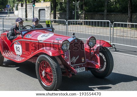 BRESCIA, ITALY - MAY 15: unidentified drivers on a vintage race car Alfa Romeo at the start of the Italian race Mille Miglia, May 15, 2014 in Brescia (BS), Italy
