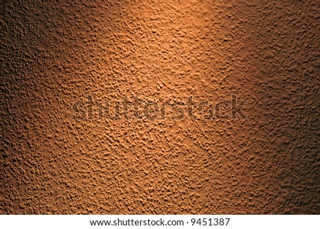 Wall surface full of grains highlighted with pin light.
