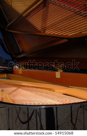 Piano with open cover. Strings inside visible like in the mirror.