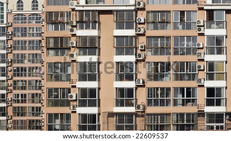 Beijing residential building facade. Lot of air conditioners attached to the wall.