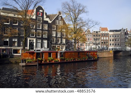 View on the canal in Amsterdam. Living boat on first plan.