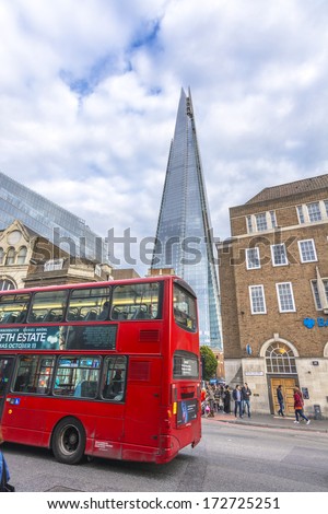 LONDON - SEPT 28: Two symbols of London, Double decker red bus and The Shard, September 28, 2013 in London. The Shard, standing at 310 meters (1,016 feet), is the tallest building in Europe.