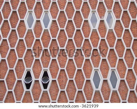 Exterior face of a 1960\'s brick building with honeycomb pattern facade