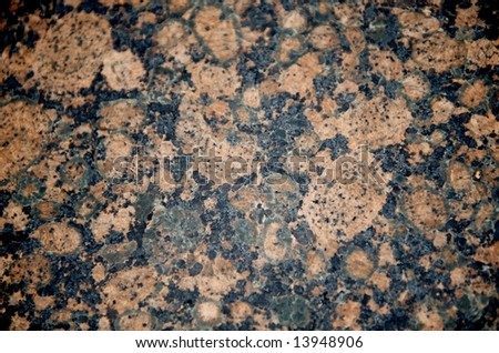 Image of a black, tan and pink patterned granite close up